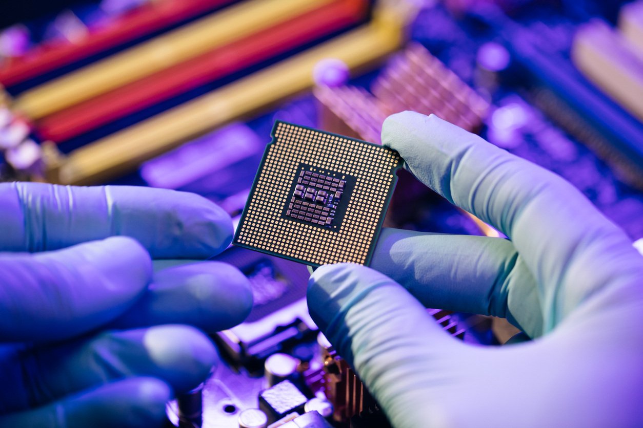 CPU computer processor shallow focus. CPU socket of the computer's motherboard. Concept of computer, motherboard, hardware and technology. Laboratory technician holds a powerful processor in his hands stock photo