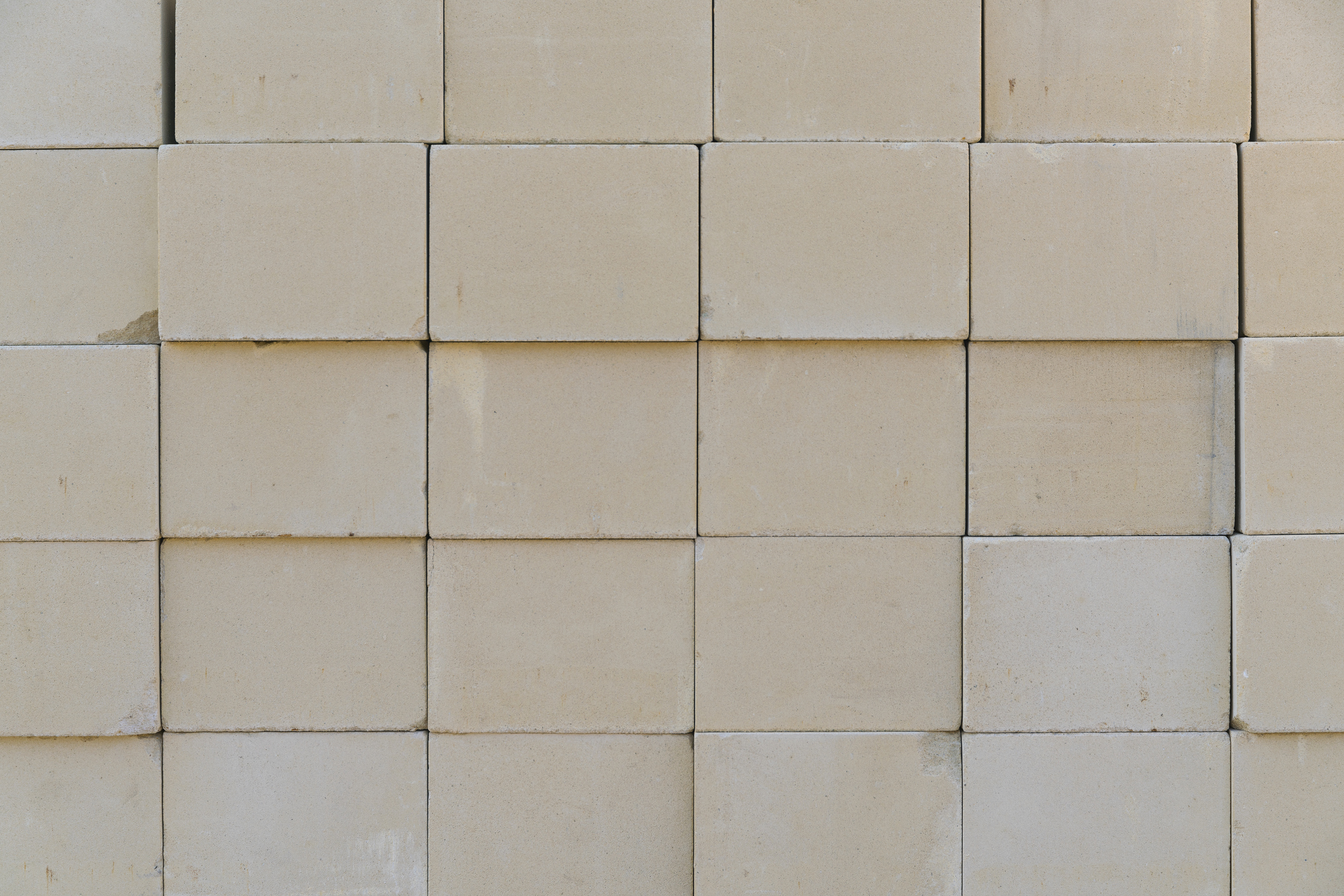 Stacked furnace bricks used for lining an industrial kiln in high-temperature applications.